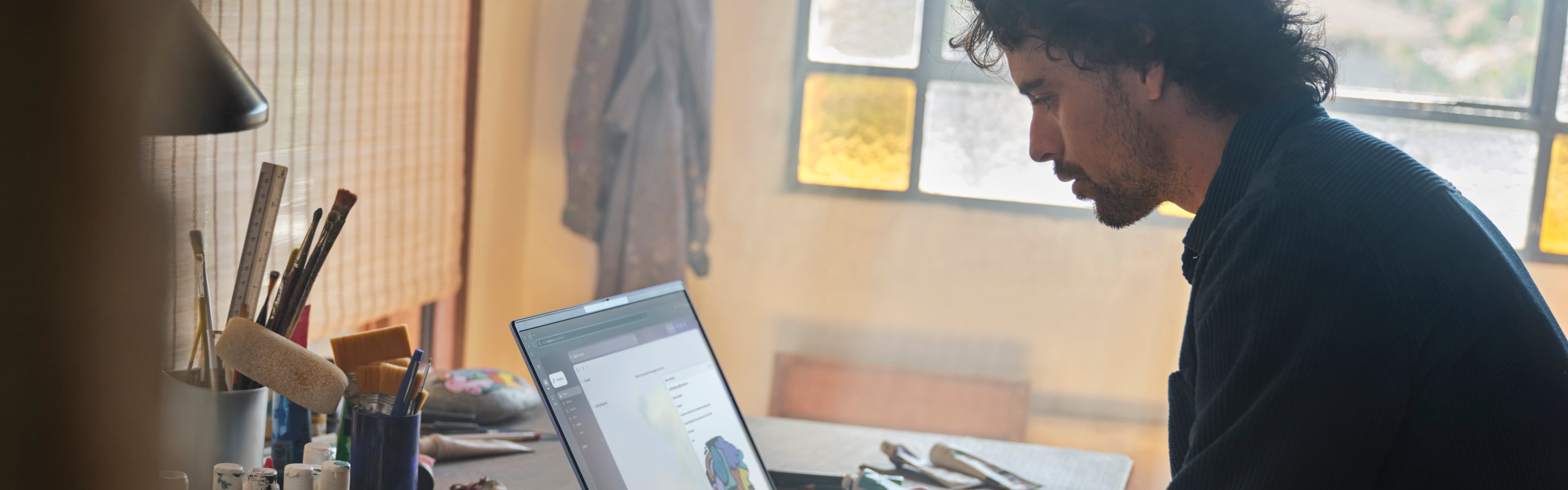 man in creative studio space using HP laptop